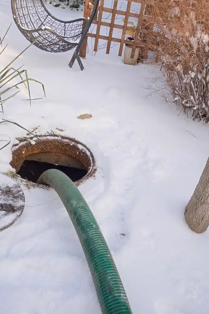 Pumping a septic tank in a backyard.
