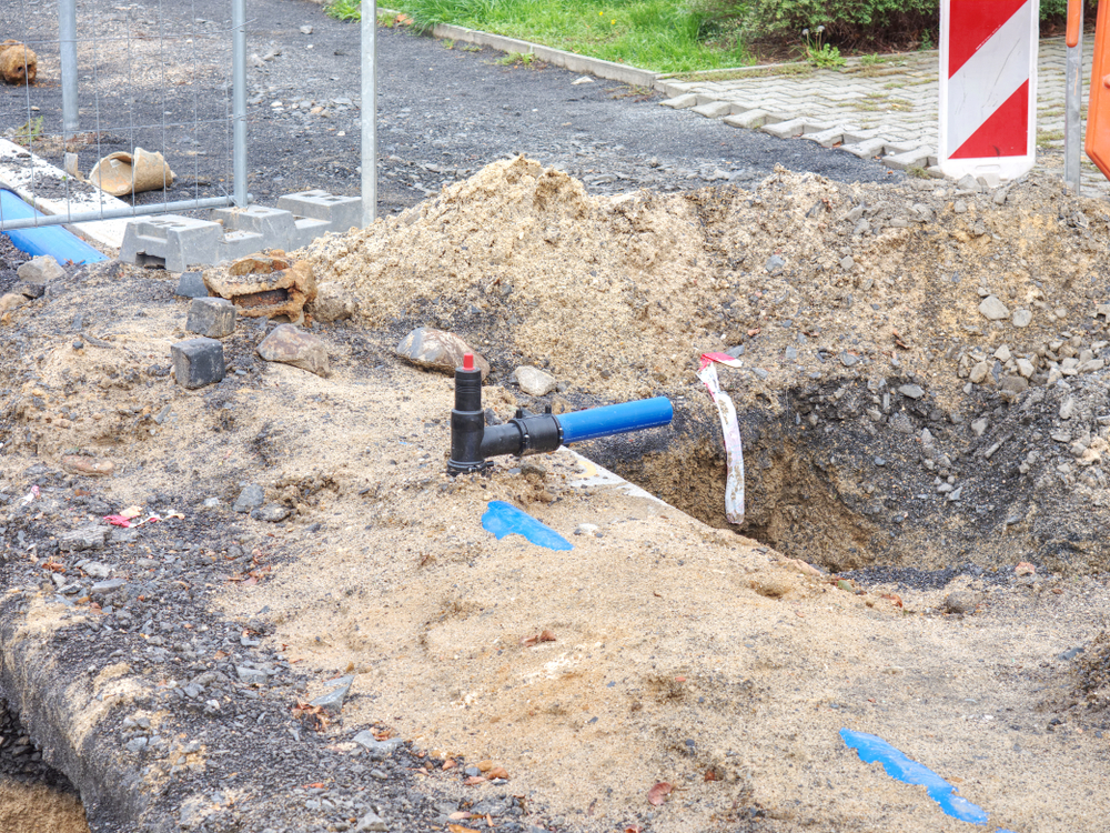 Installation of concrete sewer wells in the ground at the construction site.
